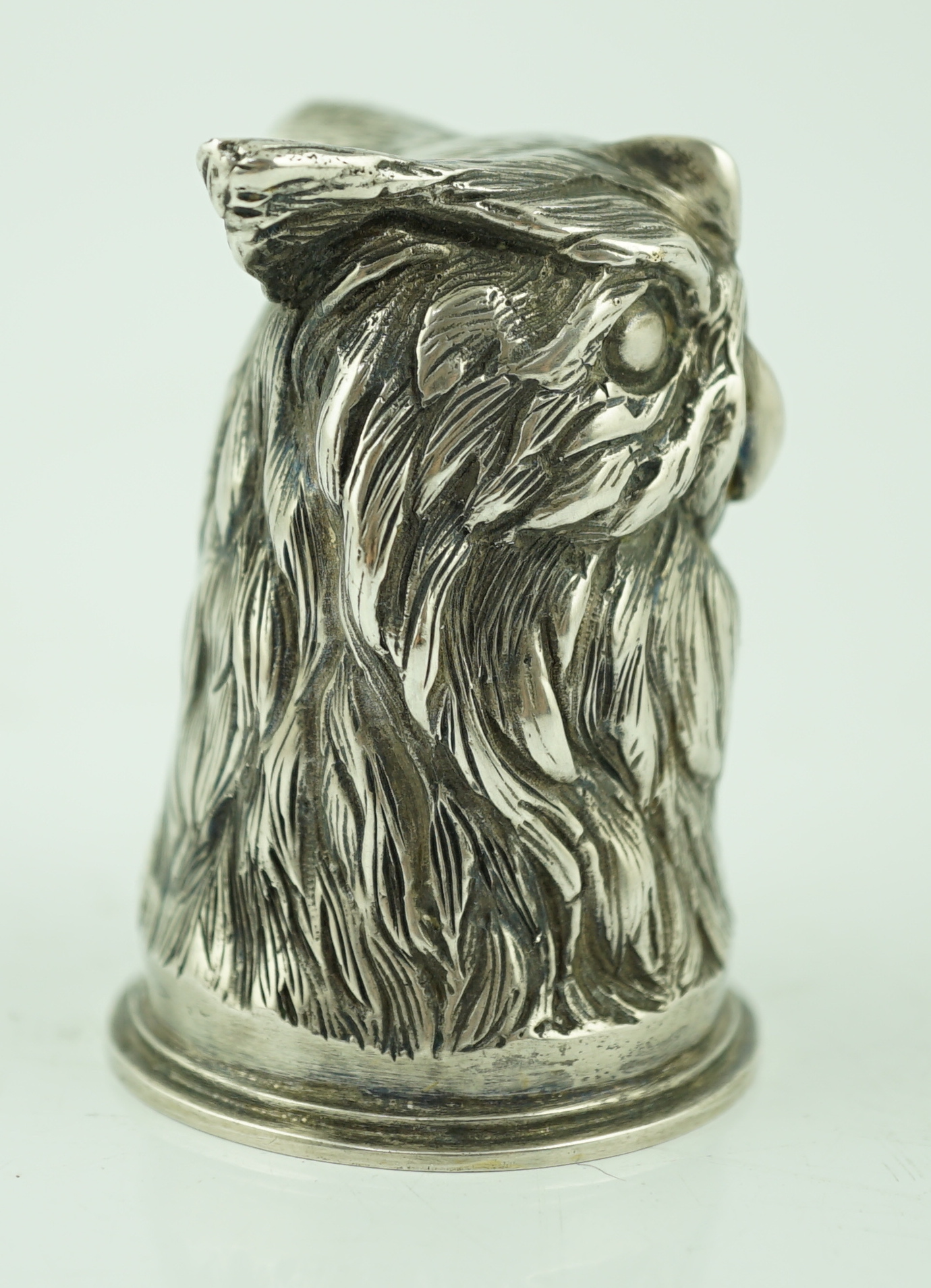 An early 20th century Russian 84 zolotnik 'stirrup' cup, modelled as the head of an owl, maker H.W.